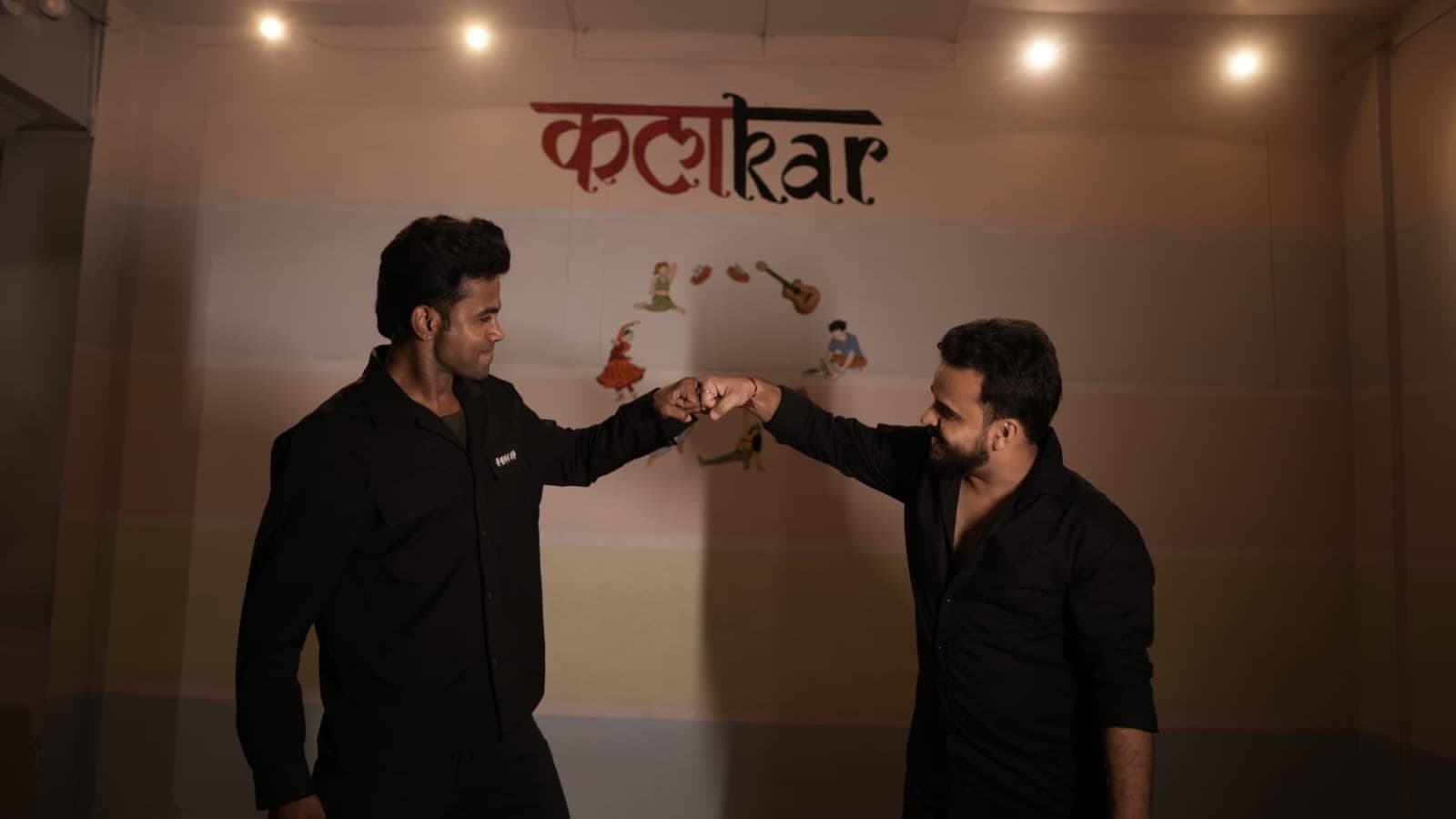 Instructors sharing a fist bump at the studio
